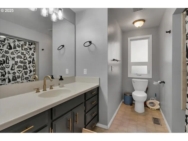 a bathroom with a sink a toilet a shower and a mirror