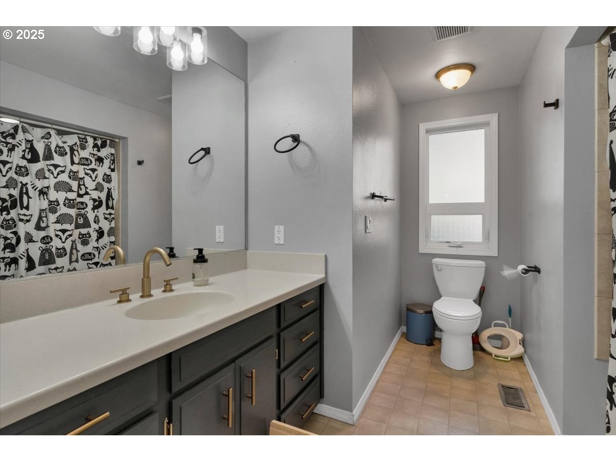 1855 Pilgrim Street Southeast Salem, OR 97302 - Photo 31 of 48 a bathroom with a sink a toilet a shower and a mirror