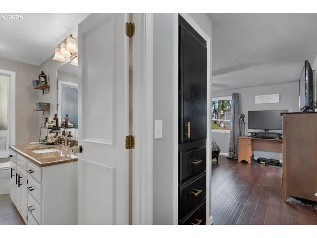 a kitchen view with furniture and wooden floor
