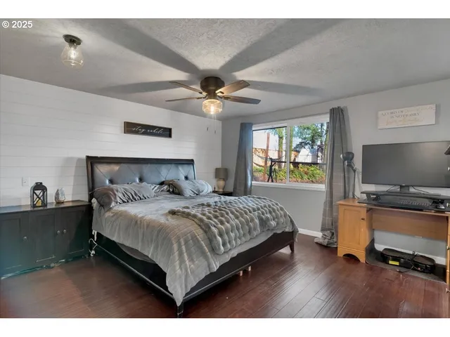 a bedroom with a bed and a flat screen tv