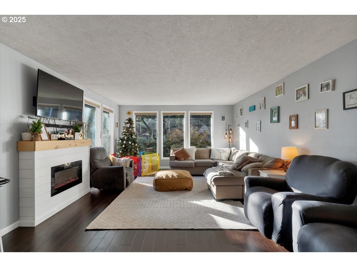 1855 Pilgrim Street Southeast Salem, OR 97302 - Photo 6 of 48 a living room with furniture a fireplace and a flat screen tv
