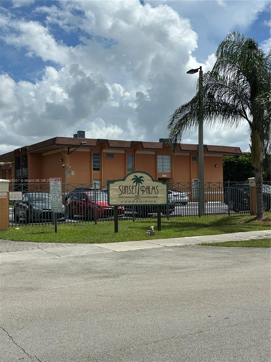 9487 Southwest 76th Street, Unit M8 Miami, FL 33173 - Photo 1 of 16 a front view of house with yard and green space