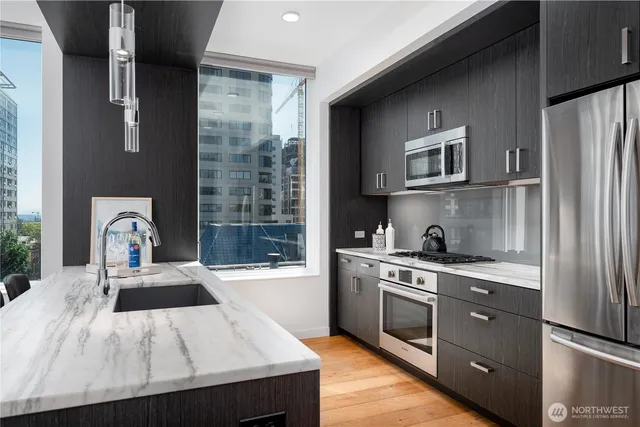 a kitchen with a sink stove and refrigerator