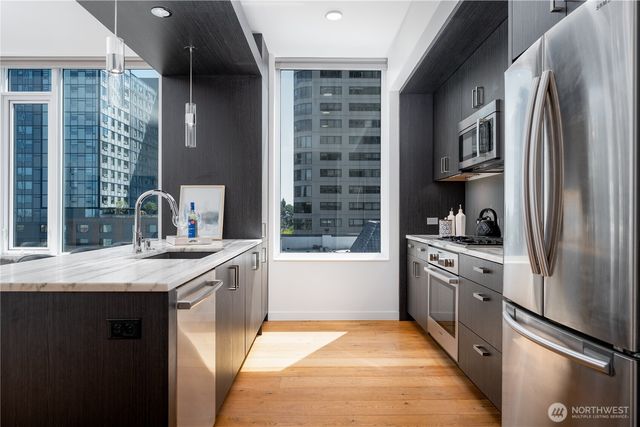 a kitchen with stainless steel appliances granite countertop a refrigerator and a sink