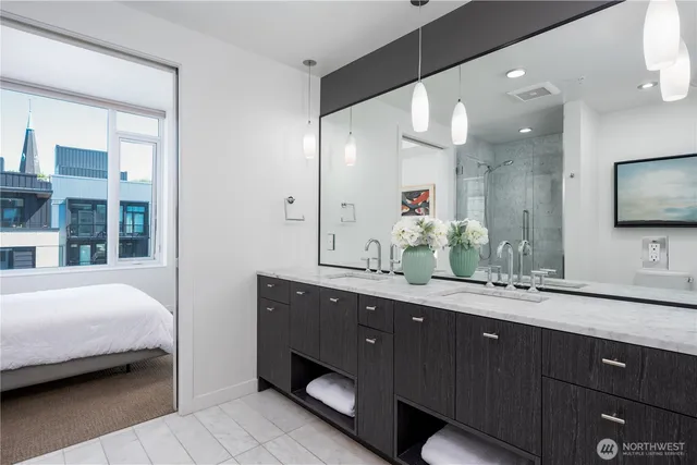 a en suite bathroom with a double vanity sink and a mirror
