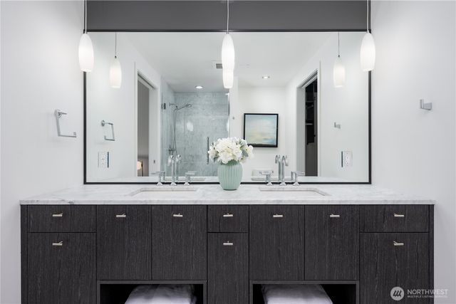 a bathroom with a granite countertop sink vanity and mirror