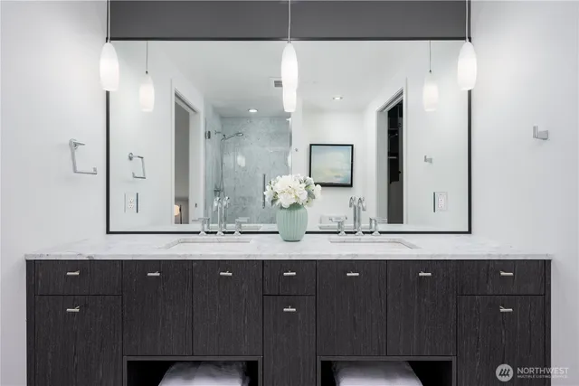 a bathroom with a granite countertop sink vanity and mirror