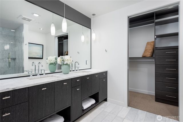 a bathroom with a double vanity sink and a mirror