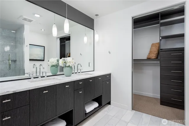 a bathroom with a double vanity sink and a mirror