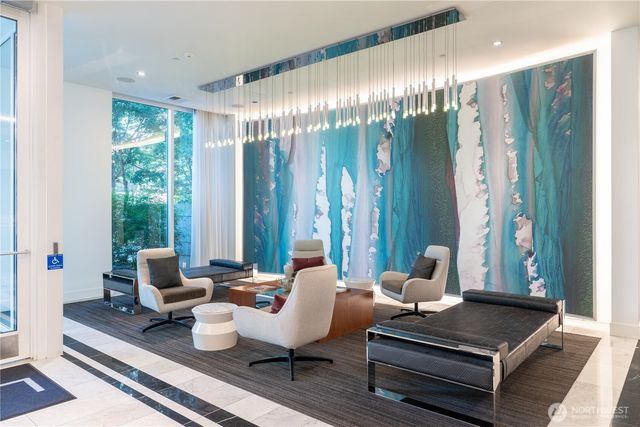 a living room with furniture and large windows