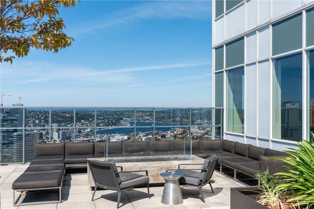 a terrace with outdoor seating and city view
