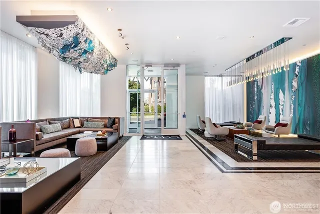 a living room with furniture and large windows