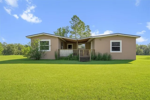 a front view of house with yard and green space