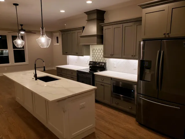 a kitchen with a sink stainless steel appliances and cabinets