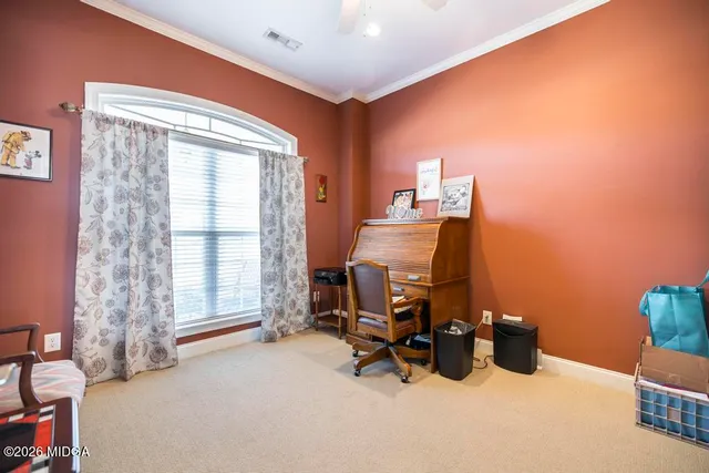 a living room with furniture a fireplace and a ceiling fan