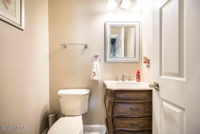 a spacious bedroom with a bed couch and a ceiling fan