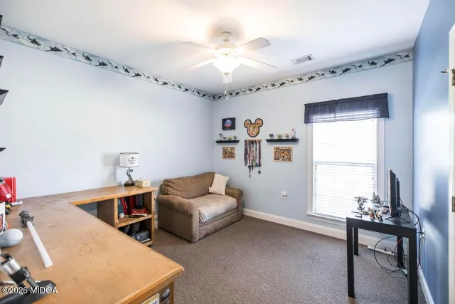 a view of a workspace with furniture and a flat screen tv