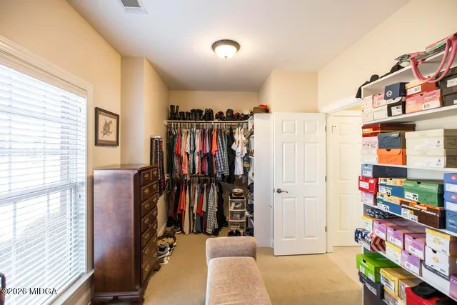 an empty room with a chandelier fan and a ceiling fan