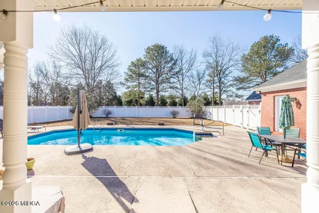 a view of a swimming pool with a patio