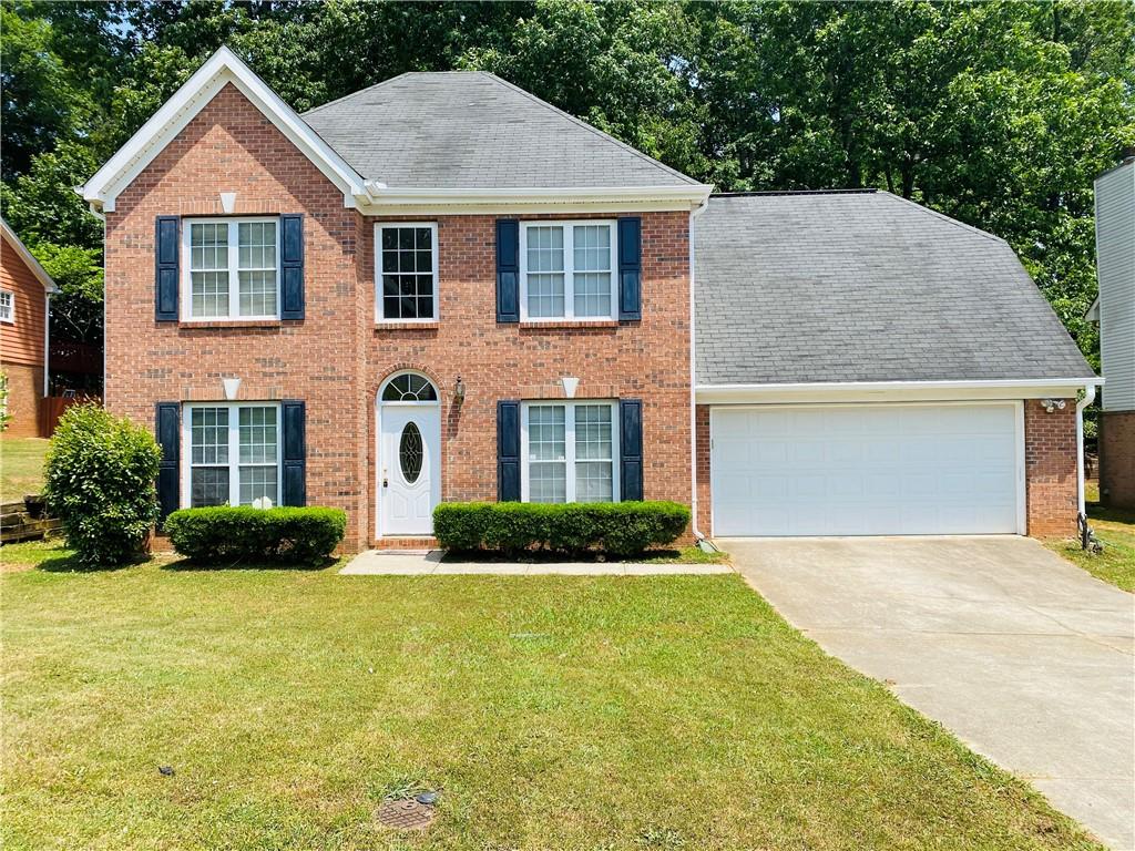 a front view of a house with a yard