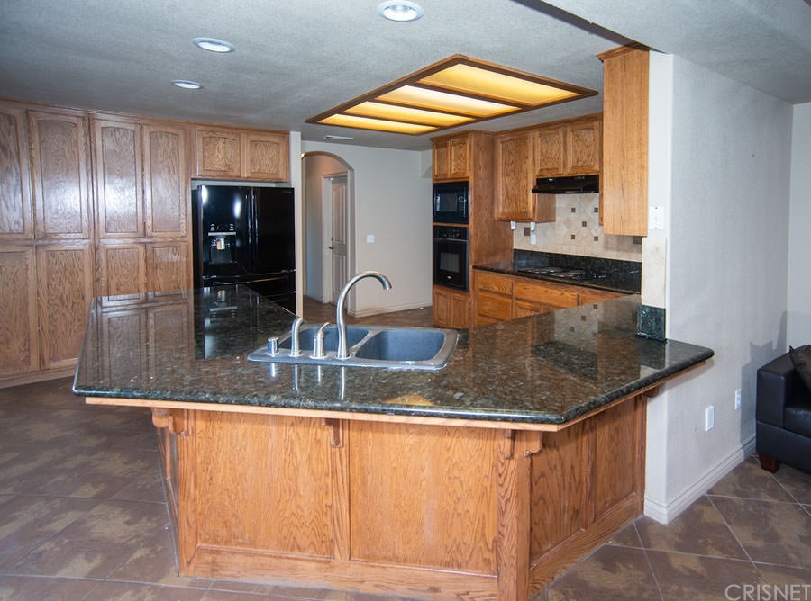 28454 Santa Rosa Road Lucerne Valley, CA 92356 - Photo 8 of 53 a kitchen with stainless steel appliances granite countertop a sink and a refrigerator