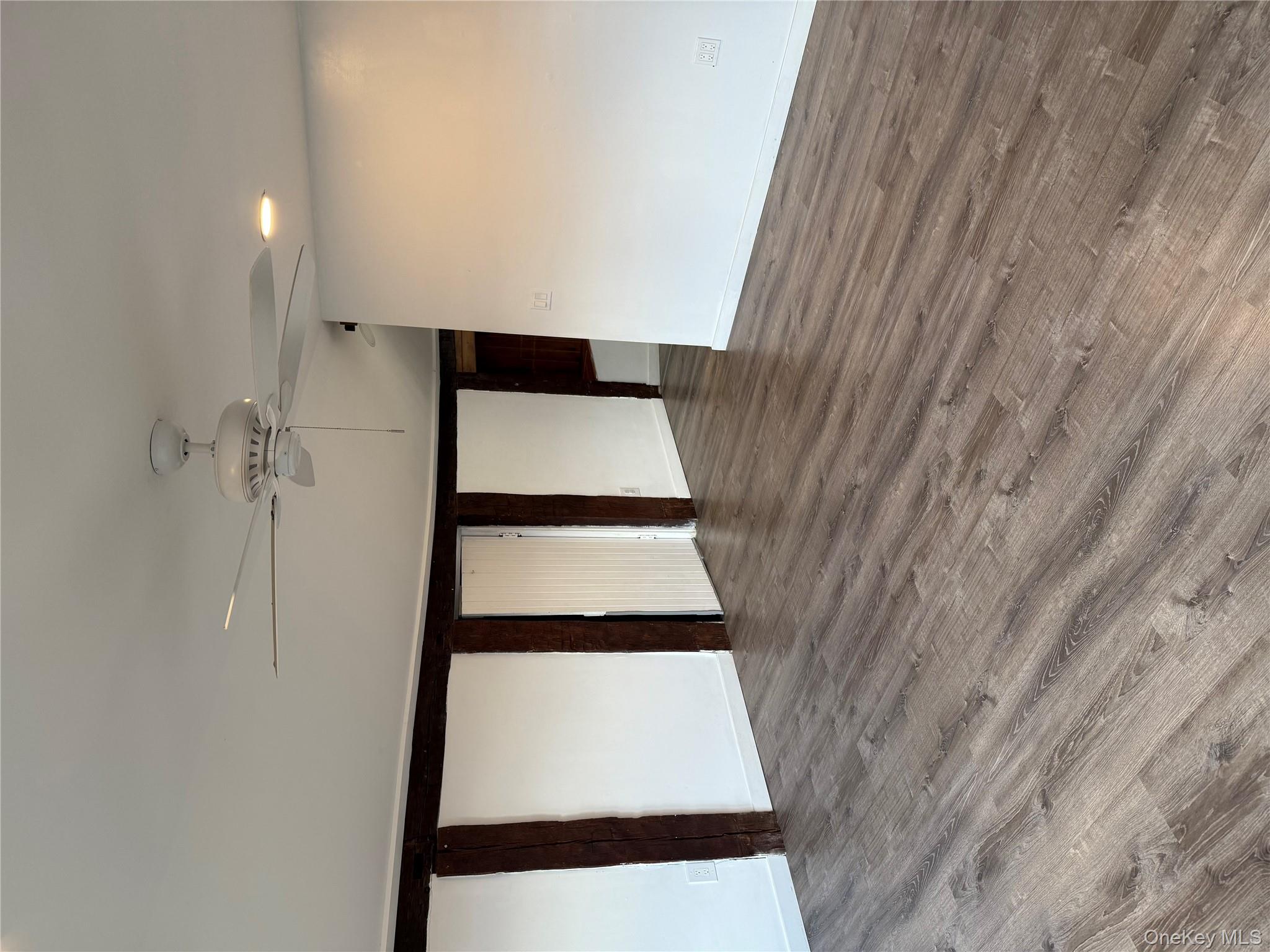 619 Salt Point Turnpike Poughkeepsie, NY 12601 - Photo 11 of 14 a view of an empty room with wooden floor and chandelier