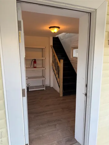a view of entryway and hall with wooden floor