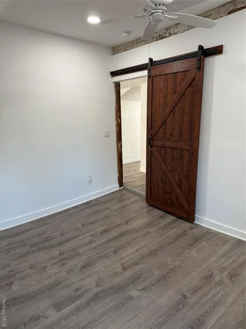 an empty room with wooden floor and closet
