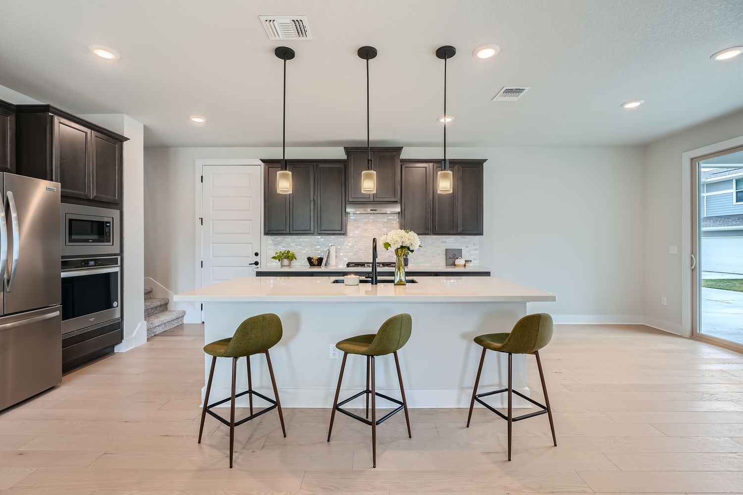 8319 Laughlin Lane Austin, TX 78744 - Photo 5 of 26 The kitchen is complete with a large island with quartz countertops and plenty of space for meal prep and casual dining.