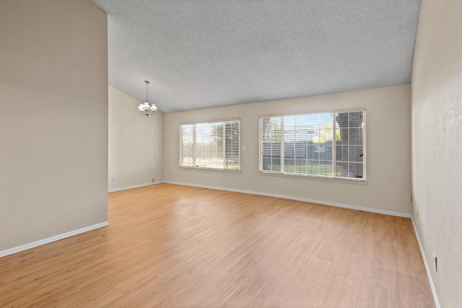986 Pebble Way Manteca, CA 95336 - Photo 5 of 42 Formal living room/dining room. Window view to backyard.