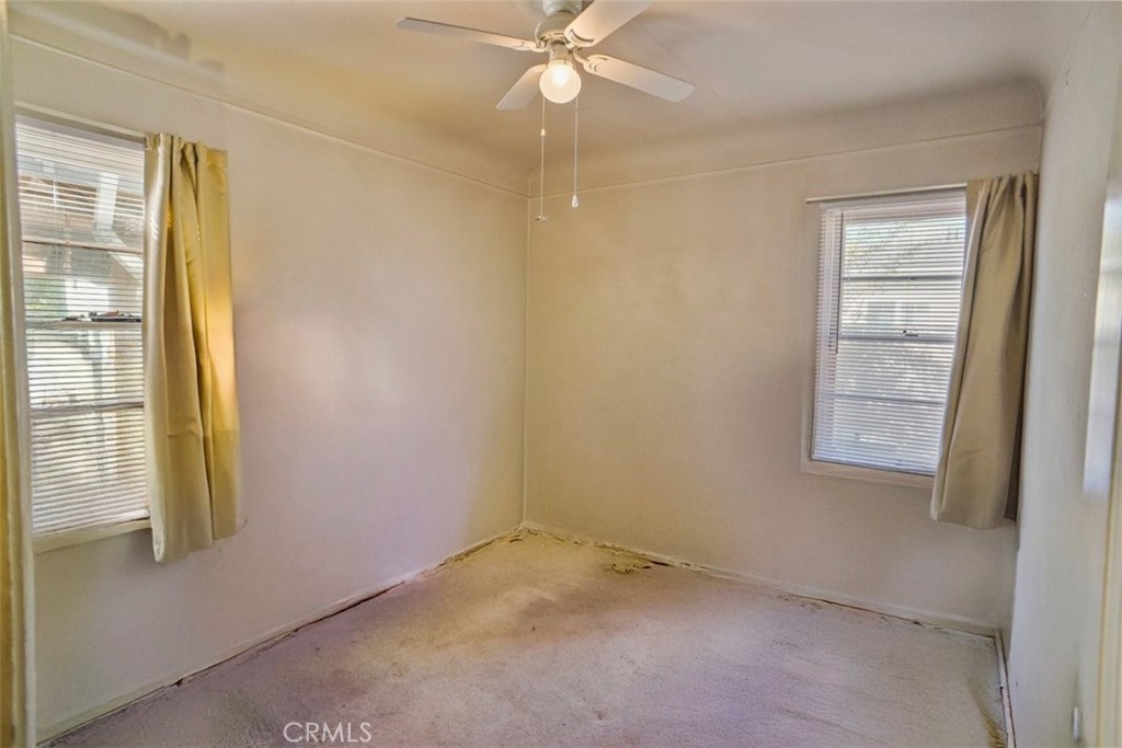 10007 Haddon Avenue Pacoima, CA 91331 - Photo 12 of 22 an empty room with windows and fan