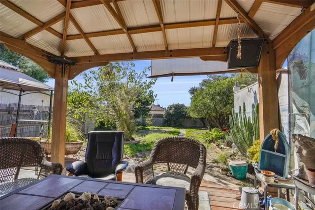 a patio table with chairs and a potted plant