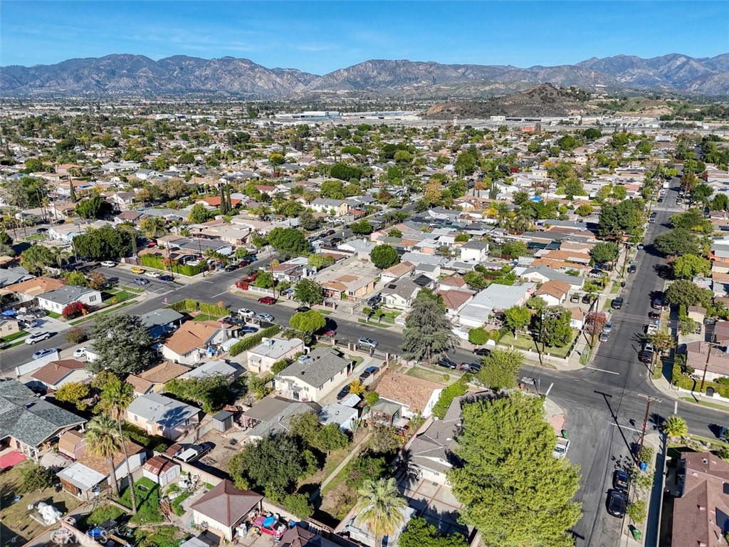 10007 Haddon Avenue Pacoima, CA 91331 - Photo 22 of 22 an aerial view of a city with lots of residential buildings and mountain view in back