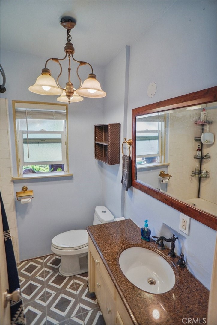 10007 Haddon Avenue Pacoima, CA 91331 - Photo 5 of 22 a bathroom with a sink toilet and mirror
