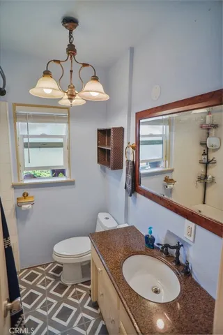 a bathroom with a sink toilet and mirror