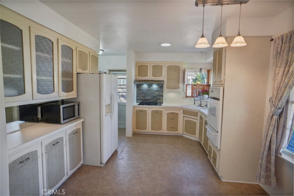 10007 Haddon Avenue Pacoima, CA 91331 - Photo 8 of 22 a kitchen with cabinets and window