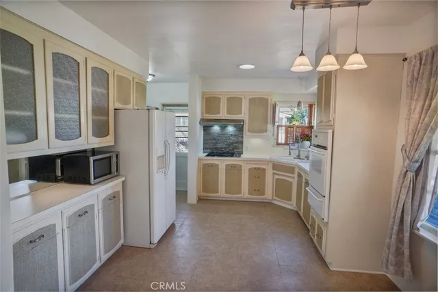a kitchen with cabinets and window