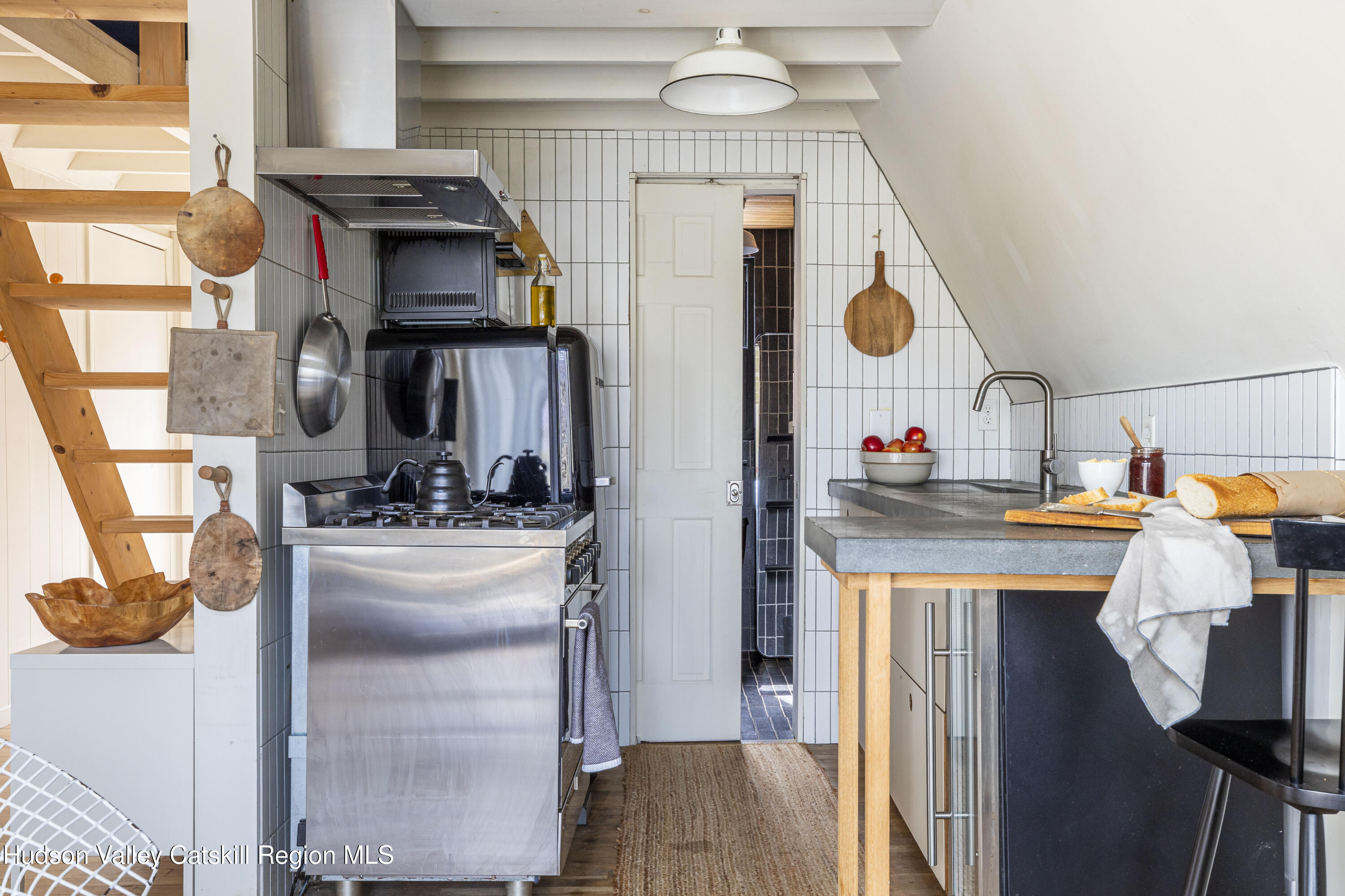 44 Smith Lane Grahamsville, NY 12740 - Photo 12 of 34 a kitchen with stainless steel appliances granite countertop a sink and a refrigerator