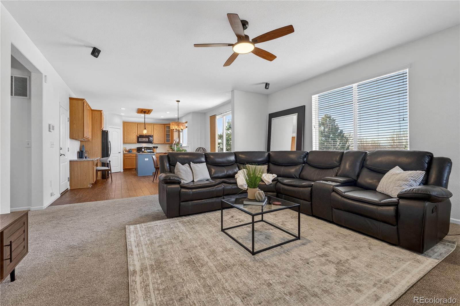 10180 Audrey Street Firestone, CO 80504 - Photo 11 of 46 a living room with furniture kitchen view and a window
