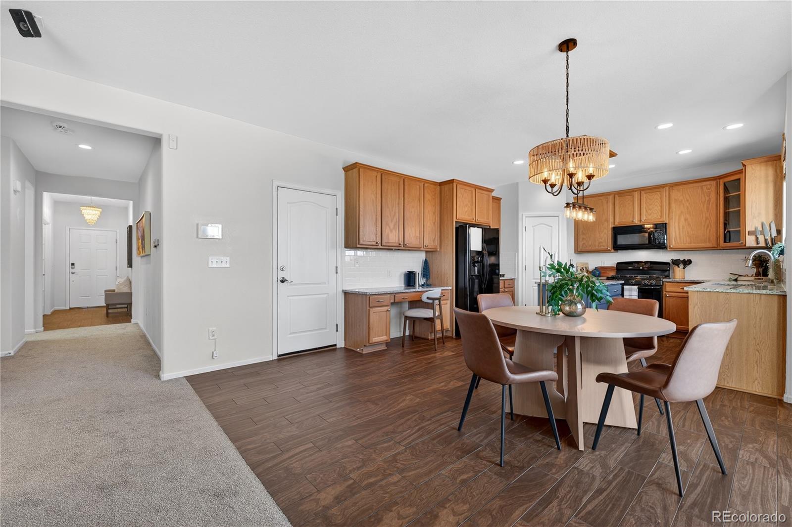 10180 Audrey Street Firestone, CO 80504 - Photo 12 of 46 a view of a dining room with furniture window and wooden floor