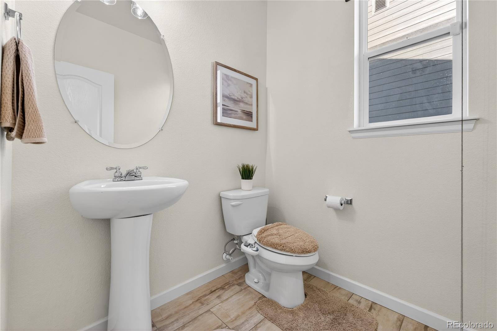 10180 Audrey Street Firestone, CO 80504 - Photo 19 of 46 a bathroom with a sink toilet and a mirror
