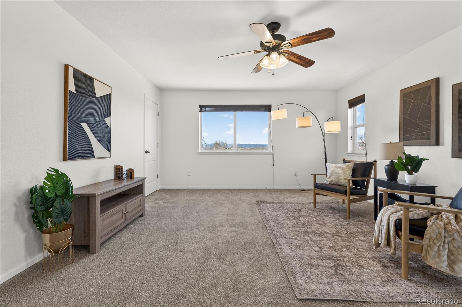 10180 Audrey Street Firestone, CO 80504 - Photo 20 of 46 a living room with furniture and a large window