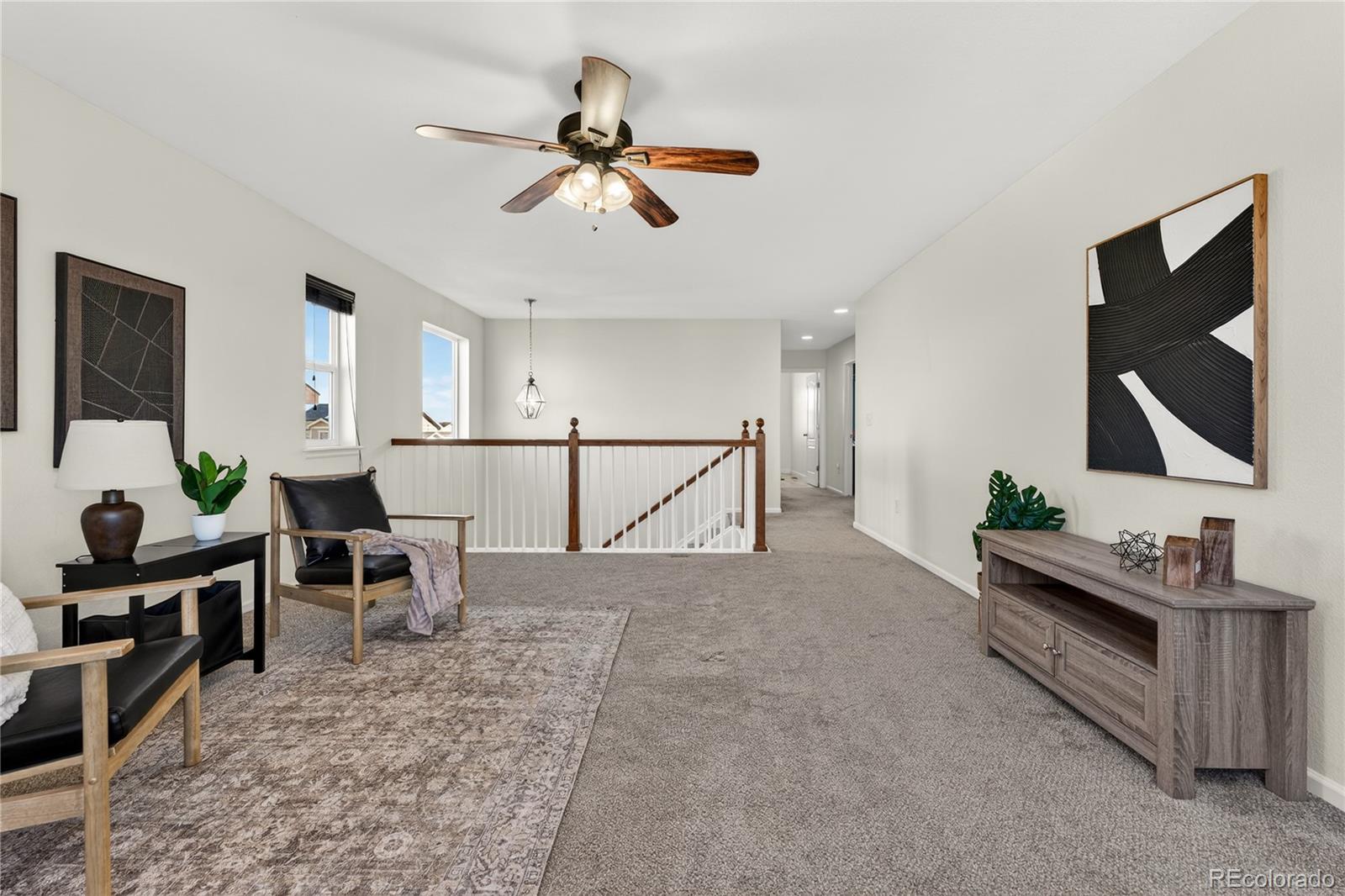 10180 Audrey Street Firestone, CO 80504 - Photo 21 of 46 a living room with furniture and a flat screen tv
