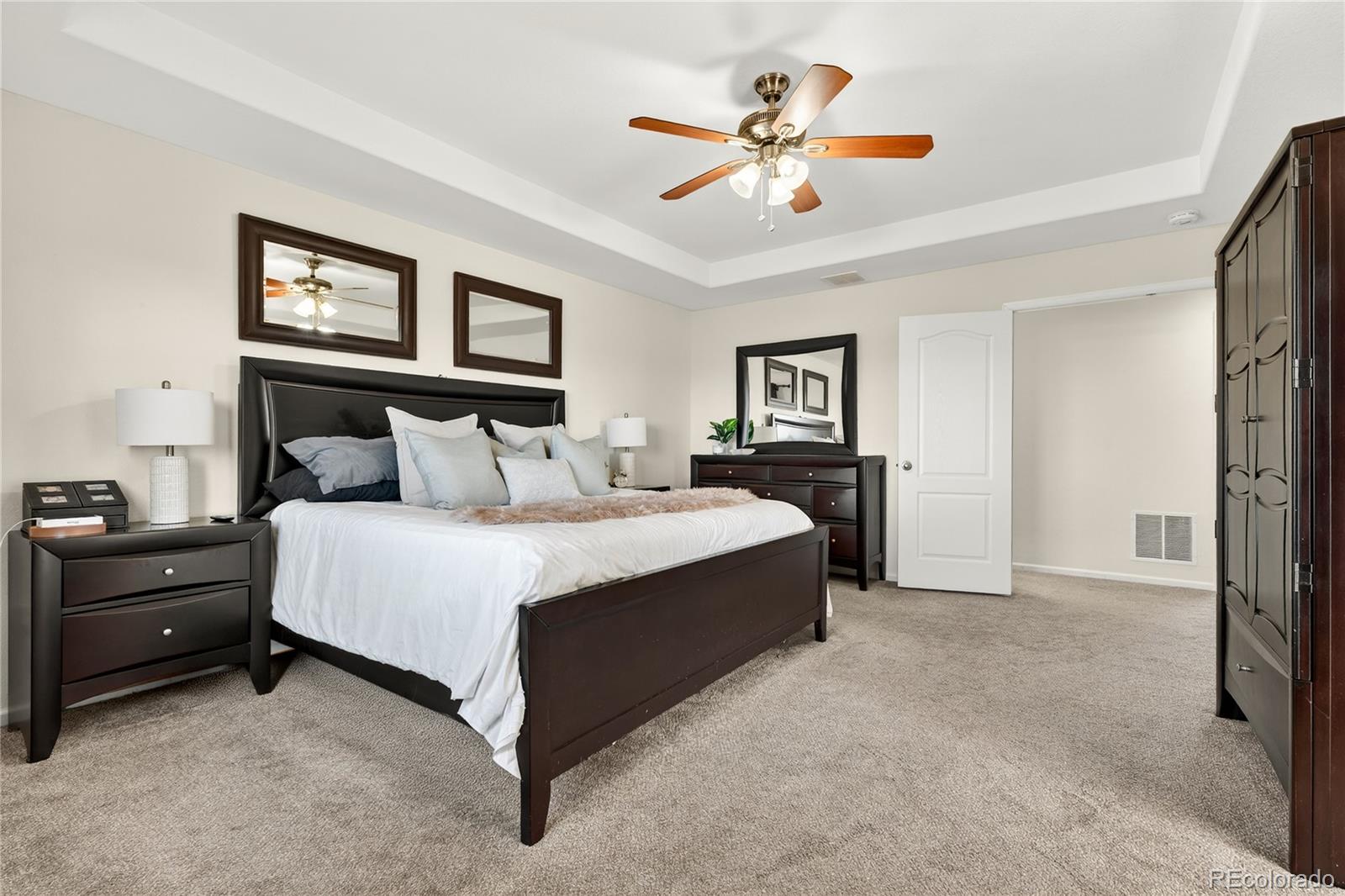 10180 Audrey Street Firestone, CO 80504 - Photo 23 of 46 a bedroom with a bed and a chandelier