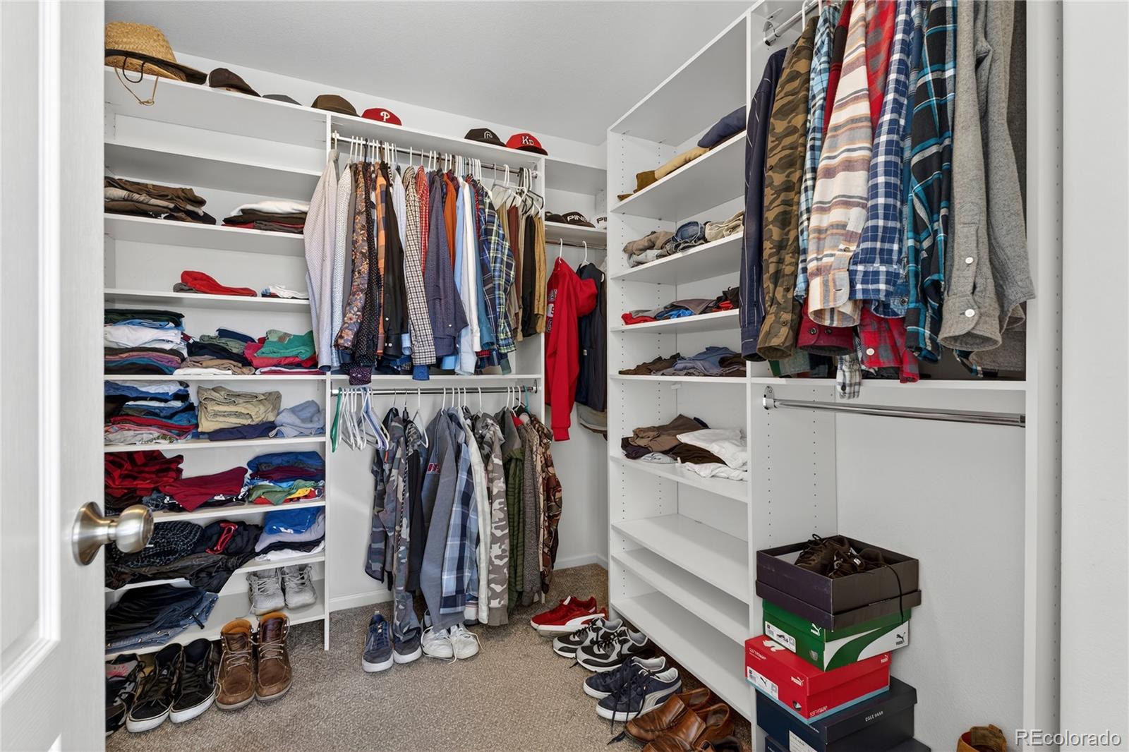 10180 Audrey Street Firestone, CO 80504 - Photo 26 of 46 a view of walk in closet with clothes and shoes