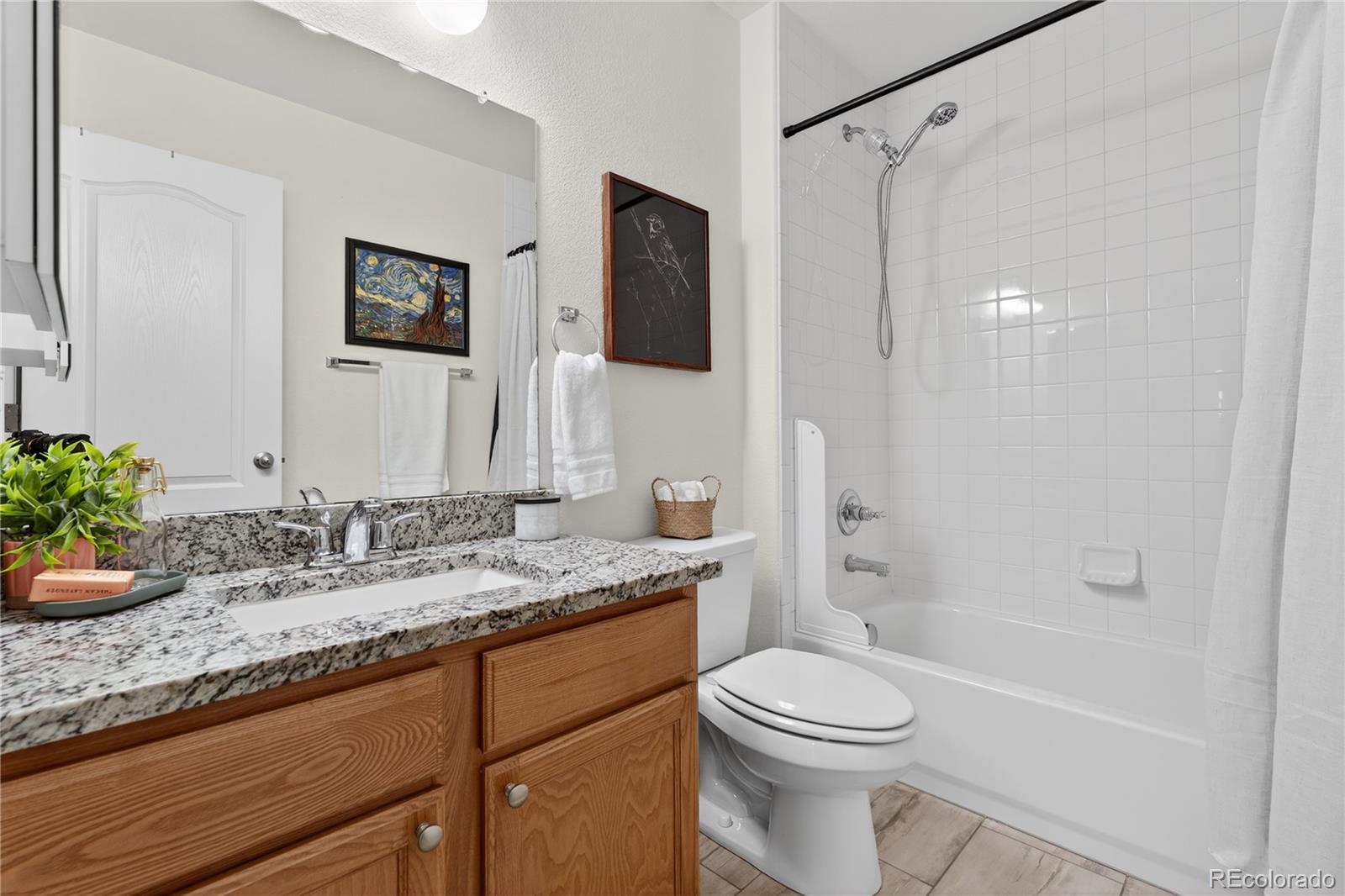 10180 Audrey Street Firestone, CO 80504 - Photo 29 of 46 a bathroom with a granite countertop sink toilet and shower