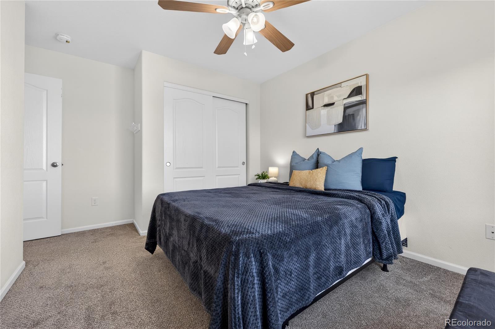 10180 Audrey Street Firestone, CO 80504 - Photo 31 of 46 a spacious bedroom with a bed and window