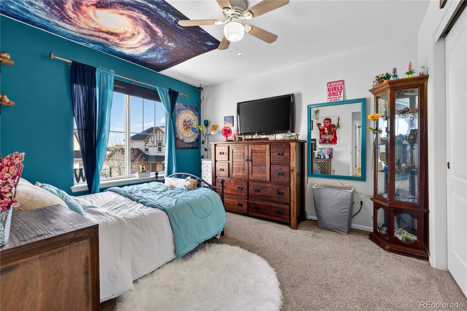 10180 Audrey Street Firestone, CO 80504 - Photo 32 of 46 a bedroom with a bed and a flat tv screen on dresser
