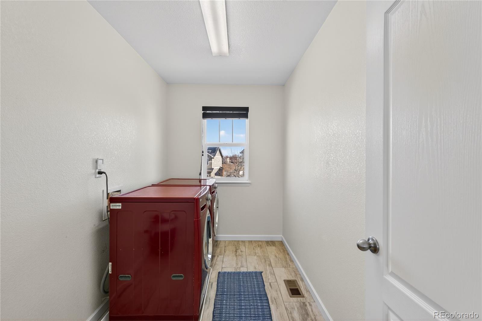 10180 Audrey Street Firestone, CO 80504 - Photo 34 of 46 a room with wooden floor and window
