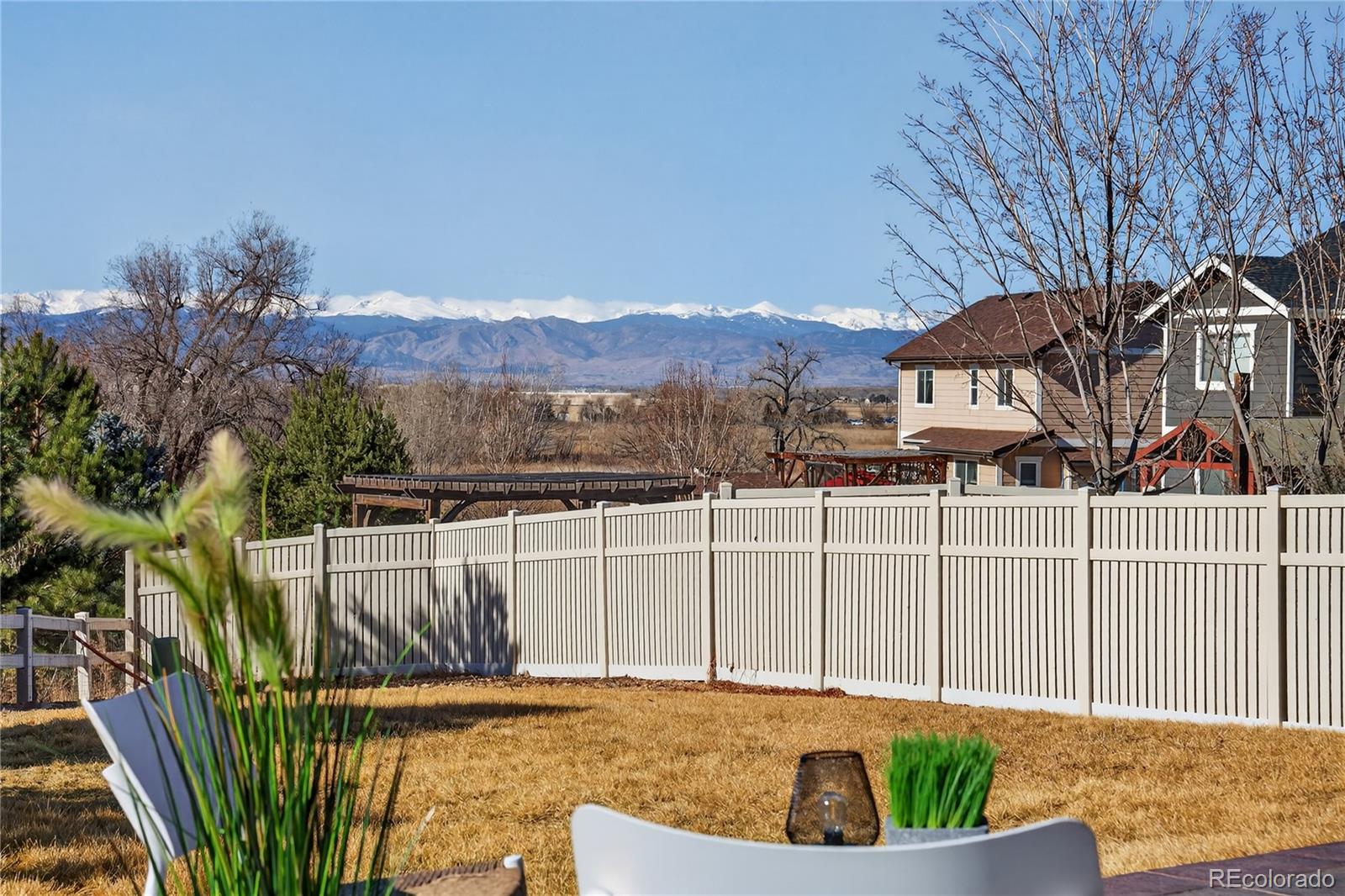 10180 Audrey Street Firestone, CO 80504 - Photo 35 of 46 a view of a houses with a small yard